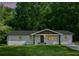 Charming house with a white exterior, dark roof, and a lush green lawn at 3344 Ridgecrest Dr, Powder Springs, GA 30127