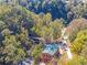 Scenic aerial view of a historic mill, covered bridges, and wooded trails at 4842 Mcpherson Ne Dr, Roswell, GA 30075