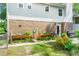 Brick back exterior featuring a patio area with a grill and raised planters at 4842 Mcpherson Ne Dr, Roswell, GA 30075
