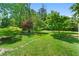Lush backyard with mature trees and a stone pathway at 4842 Mcpherson Ne Dr, Roswell, GA 30075
