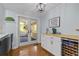 Entertainers' kitchen features bar with a wine fridge and access to the sunroom at 4842 Mcpherson Ne Dr, Roswell, GA 30075