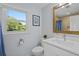 Bright bathroom with a window view, a white vanity, and a blue shower curtain at 4842 Mcpherson Ne Dr, Roswell, GA 30075