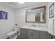 Stylish bathroom featuring shiplap walls, framed mirror, gray vanity, and marble countertop, and blue lobster artwork at 4842 Mcpherson Ne Dr, Roswell, GA 30075
