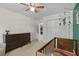 Bedroom with a wood crib and a dresser; the room includes a ceiling fan and carpeted floors at 4842 Mcpherson Ne Dr, Roswell, GA 30075