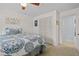 Comfortable bedroom featuring a ceiling fan, closet, and doorway at 4842 Mcpherson Ne Dr, Roswell, GA 30075