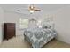 Cozy bedroom with a ceiling fan, a window, and a dresser at 4842 Mcpherson Ne Dr, Roswell, GA 30075