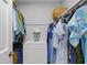 Walk-in closet with a central storage unit and organized hanging clothes at 4842 Mcpherson Ne Dr, Roswell, GA 30075
