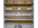 Linen closet with wooden shelves and decorative baskets, providing ample storage space at 4842 Mcpherson Ne Dr, Roswell, GA 30075
