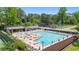 Large community pool with ample seating and umbrellas, perfect for relaxation and recreation at 4842 Mcpherson Ne Dr, Roswell, GA 30075