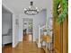 Bright foyer with hardwood floors, modern chandelier, and view of the staircase at 4842 Mcpherson Ne Dr, Roswell, GA 30075