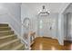 Welcoming foyer features hardwood floors, coat closet, and access to the staircase at 4842 Mcpherson Ne Dr, Roswell, GA 30075