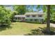Charming two-story home featuring a lush front lawn, manicured bushes, and brick accents at 4842 Mcpherson Ne Dr, Roswell, GA 30075