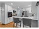 Bright kitchen with white cabinets, stainless steel appliances, and breakfast bar at 4842 Mcpherson Ne Dr, Roswell, GA 30075
