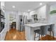 Modern kitchen with white cabinets, stainless steel appliances, and a convenient breakfast bar at 4842 Mcpherson Ne Dr, Roswell, GA 30075