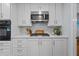 Updated kitchen features white cabinets, subway tile backsplash and stainless steel appliances at 4842 Mcpherson Ne Dr, Roswell, GA 30075