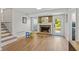 Living room with exposed brick fireplace, access to backyard, and stairs at 4842 Mcpherson Ne Dr, Roswell, GA 30075