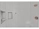 Close up of the shower featuring herringbone tile and built-in shelving at 4842 Mcpherson Ne Dr, Roswell, GA 30075