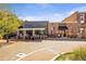 Shops and restaurants along a brick walkway with outdoor seating at 4842 Mcpherson Ne Dr, Roswell, GA 30075