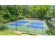 Well-maintained community tennis courts surrounded by lush greenery at 4842 Mcpherson Ne Dr, Roswell, GA 30075