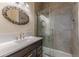 Beautiful bathroom with glass shower, modern hardware and decorative oval mirror at 537 Winton Ne Ter, Atlanta, GA 30308