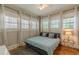 Bright bedroom with hardwood floors, three windows and a ceiling fan at 537 Winton Ne Ter, Atlanta, GA 30308