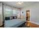 Bedroom with ensuite bathroom, natural light, hardwood floors and gray decor at 537 Winton Ne Ter, Atlanta, GA 30308