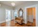 Hallway features hardwood floors, stylish couch, and decorative mirror with a view to a bathroom and kitchen at 537 Winton Ne Ter, Atlanta, GA 30308