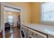 Laundry area featuring stacked washer and dryer, adjacent to a kitchen with breakfast table at 537 Winton Ne Ter, Atlanta, GA 30308