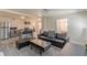 Open-concept living area boasts a modern kitchen, sleek leather furniture and chic area rug at 537 Winton Ne Ter, Atlanta, GA 30308