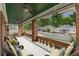Inviting covered porch with brick columns, ceiling fans, and comfortable seating overlooking the neighborhood at 537 Winton Ne Ter, Atlanta, GA 30308