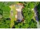 Aerial view of a property showcasing its spacious lot, landscaping, and proximity to the road at 1588 Peachtree Cir, Lawrenceville, GA 30043