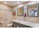 This bathroom has double sinks, granite countertops, tiled walls and blue glass accents at 1588 Peachtree Cir, Lawrenceville, GA 30043