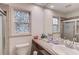 This bathroom features decorative windows and an integrated sink, toilet and vanity at 1588 Peachtree Cir, Lawrenceville, GA 30043