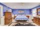 This bedroom features bright blue walls, light floors, and a large decorative rug at 1588 Peachtree Cir, Lawrenceville, GA 30043