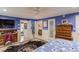 This bedroom features a decorative rug, doors to the ensuite bath and hallway, and bright blue walls at 1588 Peachtree Cir, Lawrenceville, GA 30043
