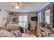 This bedroom is decorated with colorful items, hard wood floors, and bright accents at 1588 Peachtree Cir, Lawrenceville, GA 30043