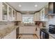 Modern kitchen with white cabinets, granite countertops, stainless steel appliances, and ample storage space at 1588 Peachtree Cir, Lawrenceville, GA 30043