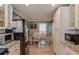 Open-concept kitchen with a view of the dining area, featuring white cabinets and granite countertops at 1588 Peachtree Cir, Lawrenceville, GA 30043