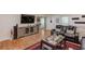 Cozy living room with hardwood floors, a sleek entertainment center, and comfortable leather seating at 1588 Peachtree Cir, Lawrenceville, GA 30043