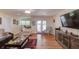 Bright living room with hardwood floors, a large TV, and comfortable seating, perfect for relaxing and entertaining at 1588 Peachtree Cir, Lawrenceville, GA 30043