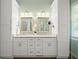 Bathroom featuring dual sinks, marble countertops, and white cabinetry with ample storage at 4445 Ansley Ln, Cumming, GA 30040