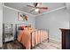 Comfortable bedroom with a metal frame bed, wood floors, neutral paint and ample lighting at 4445 Ansley Ln, Cumming, GA 30040