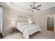 Bright bedroom featuring tray ceilings, neutral walls, a ceiling fan, and carpeted floors at 4445 Ansley Ln, Cumming, GA 30040