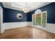 Formal dining room featuring hardwood floors, wainscoting, and natural light at 4445 Ansley Ln, Cumming, GA 30040