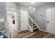 Entryway featuring hardwood floors, staircase with white banister, and neutral colored walls at 4445 Ansley Ln, Cumming, GA 30040