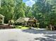 Charming home with well-maintained landscaping and a lush, green surrounding tree canopy at 4445 Ansley Ln, Cumming, GA 30040