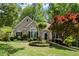 Beautifully landscaped home with manicured lawn, stone accents, and mature trees at 4445 Ansley Ln, Cumming, GA 30040