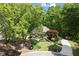 A well-maintained home with a manicured lawn, mature trees, and a winding driveway at 4445 Ansley Ln, Cumming, GA 30040
