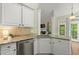 Bright kitchen boasts white cabinets, stainless appliances, and granite countertops, creating a functional design at 4445 Ansley Ln, Cumming, GA 30040