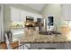 Bright kitchen features granite counters, stainless appliances, and a functional breakfast bar with seating at 4445 Ansley Ln, Cumming, GA 30040